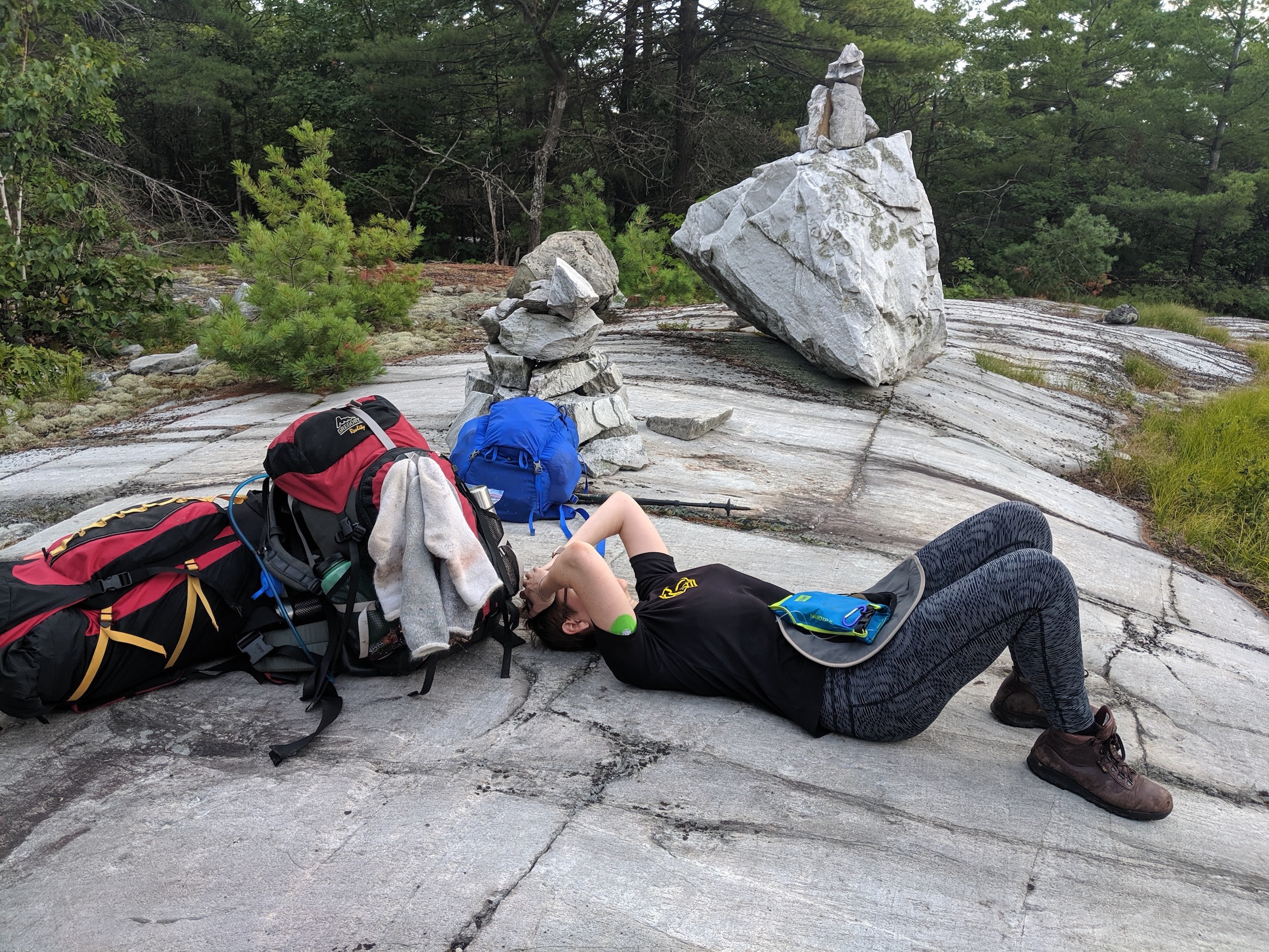 Me stretched out on a rock during a short break, totally miserable. I strongly recommend against getting sick in the backcountry when the only way out is onward.