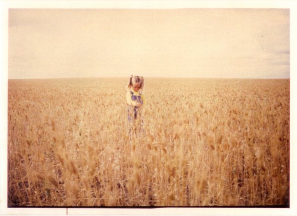 Me as a young child standing in a wheat field in Saskatchewan